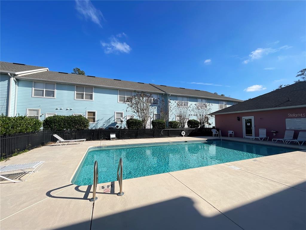3930 Southwest 20th Avenue, Unit 1902 Gainesville, FL 32607 - Photo 10 of 15 a view of a house with pool yard and a patio