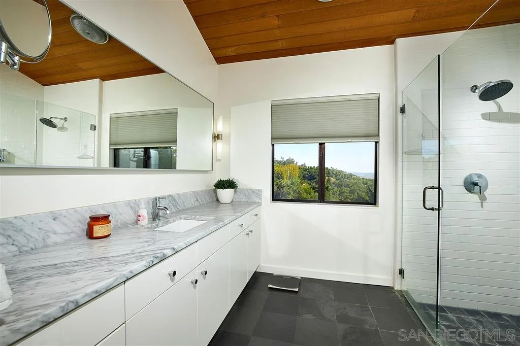 2255 Country Road Fallbrook, CA 92028 - Photo 10 of 24 a bathroom with a granite countertop sink a mirror and shower