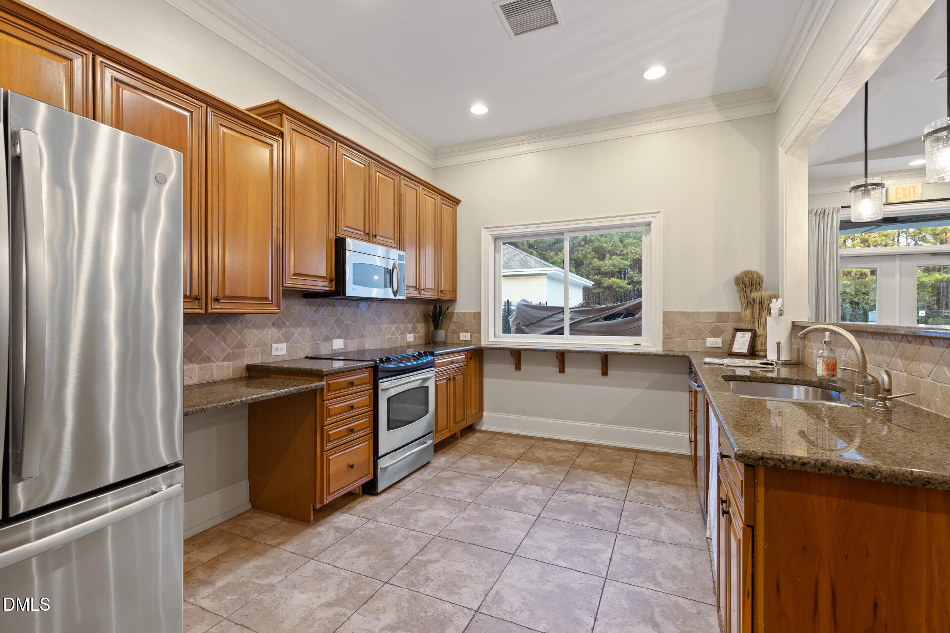 112 Winding Ridge Road Durham, NC 27713 - Photo 79 of 84 a kitchen with stainless steel appliances granite countertop a stove sink and cabinets