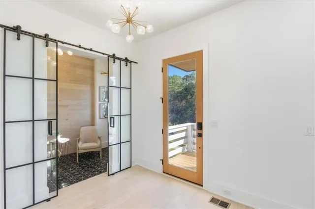 an open kitchen with granite countertop a stove a sink and a dining table with chairs
