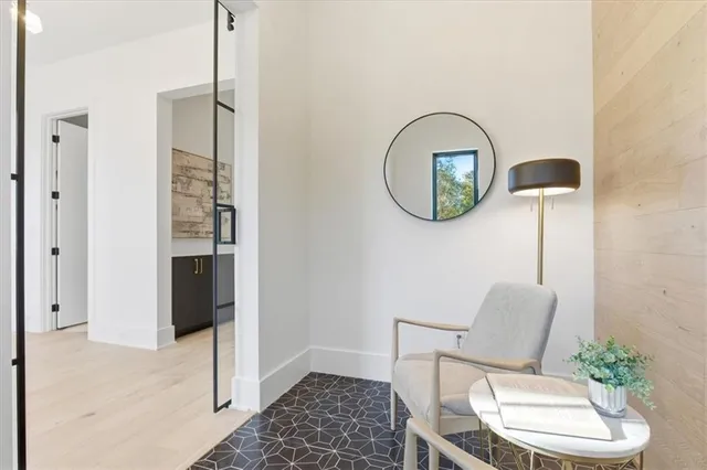 a view of a kitchen area with furniture and wooden floor