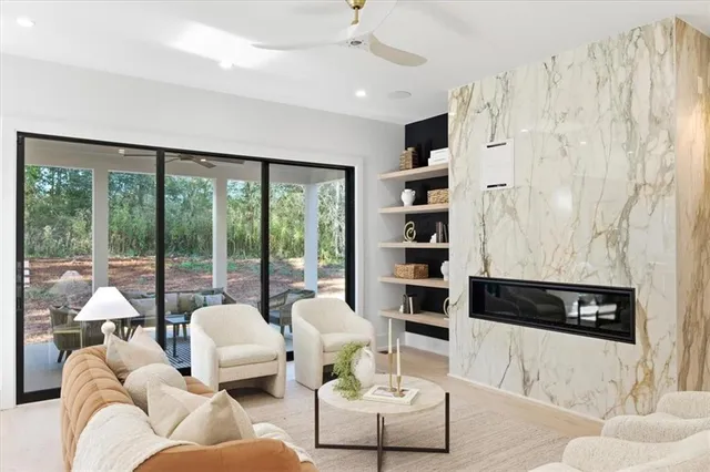 a living room with furniture and a potted plant