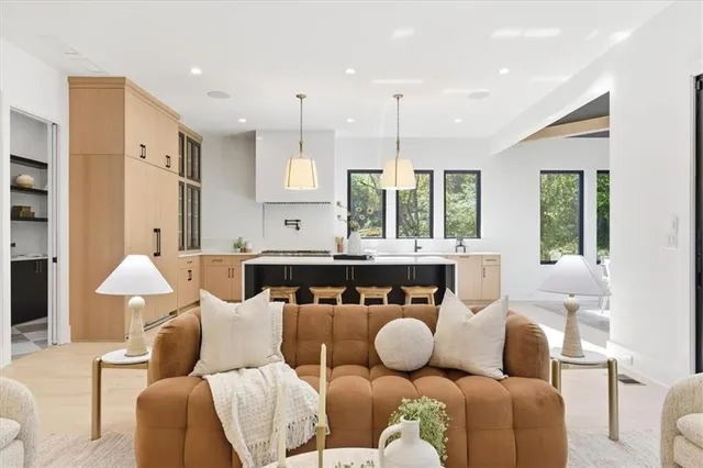 a spacious bedroom with a bed and a chandelier