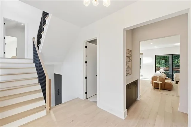 a living room with furniture kitchen view and large windows