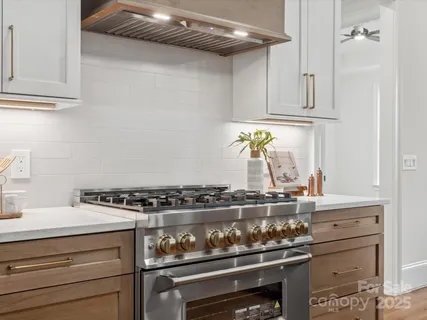 a stove top oven sitting inside of a kitchen