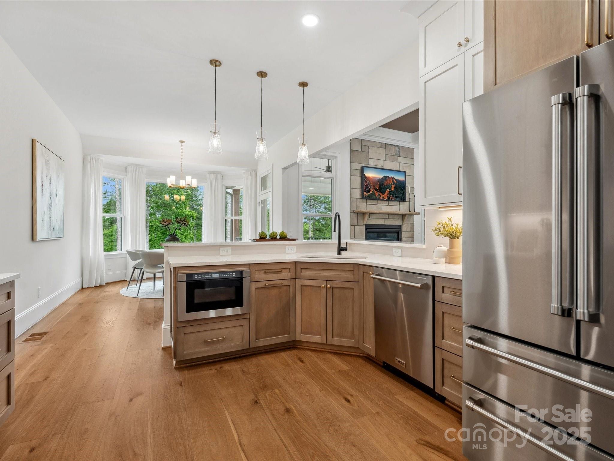 2024 Jumping Run Connelly Springs, NC 28612 - Photo 15 of 48 a kitchen with stainless steel appliances granite countertop a refrigerator a oven a sink dishwasher and a stove with wooden floor