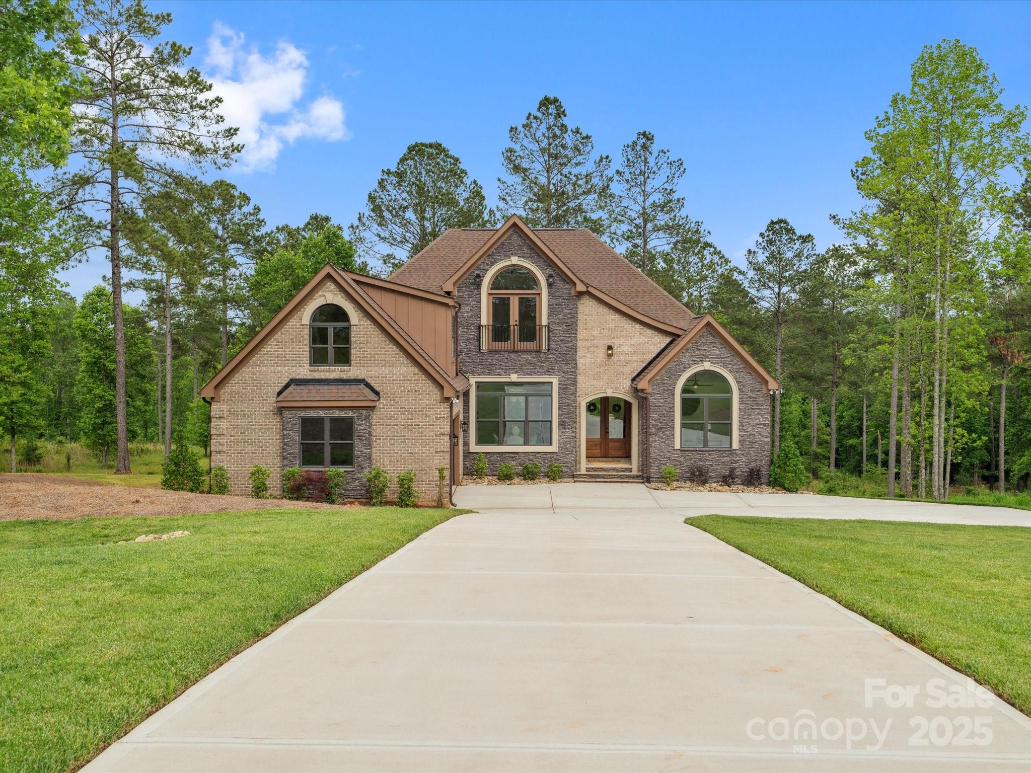 2024 Jumping Run Connelly Springs, NC 28612 - Photo 2 of 48 a front view of a house with a garden
