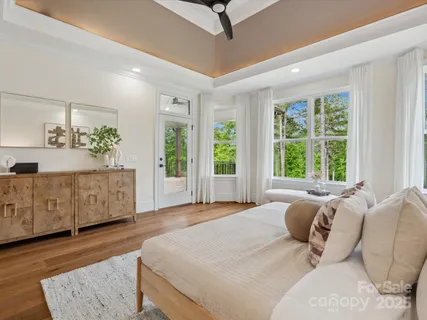 a spacious bedroom with a large bed and a dresser