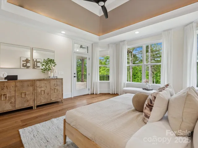 a spacious bedroom with a large bed and a dresser