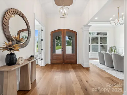 a view of a livingroom with furniture and hardwood floor