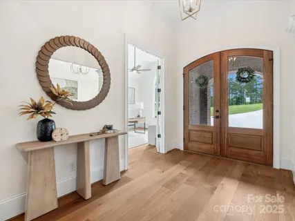 a view of a room with wooden floor and white walls