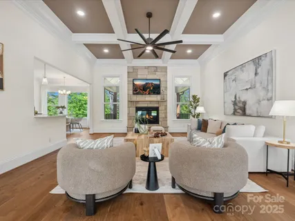 a living room with fireplace furniture and a large window