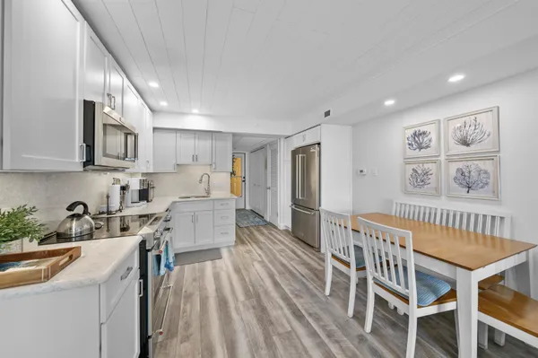 a kitchen with white cabinets stainless steel appliances and sink