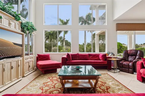 a dining room with furniture a chandelier and window
