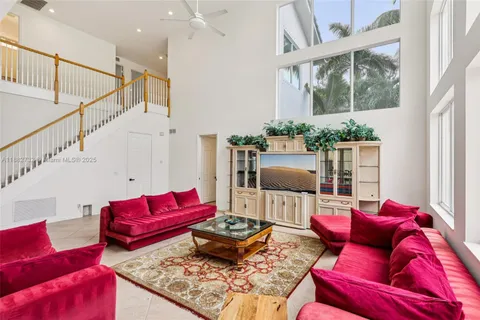 a bedroom with a bed a couch and a window