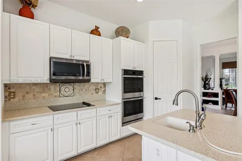 a spacious bathroom with a granite countertop sink a mirror and a shower