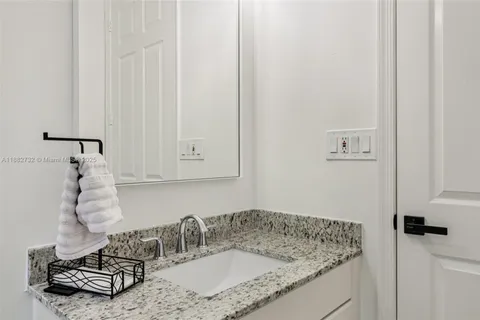 a bedroom with furniture and a mirror