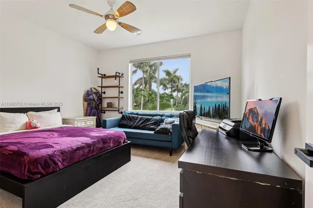 a spacious bathroom with a granite countertop sink a mirror and a shower