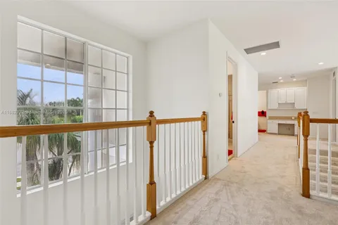 a dining room with furniture water view and a floor to ceiling window