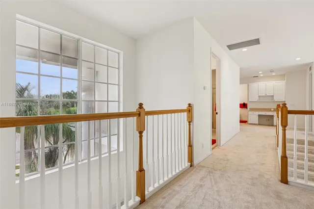a dining room with furniture water view and a floor to ceiling window