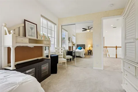 an aerial view of a residential houses with outdoor space and trees