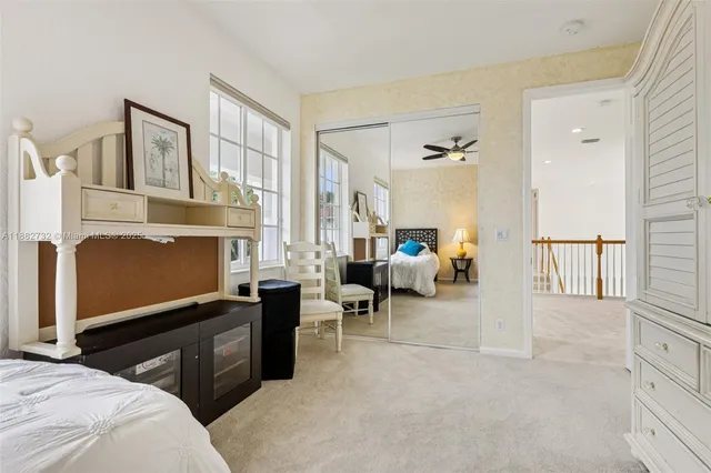 an aerial view of a residential houses with outdoor space and trees