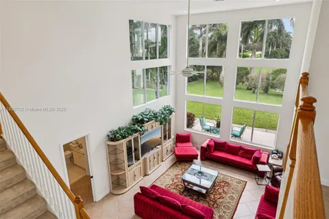 a dining room with furniture potted plants and wooden floor