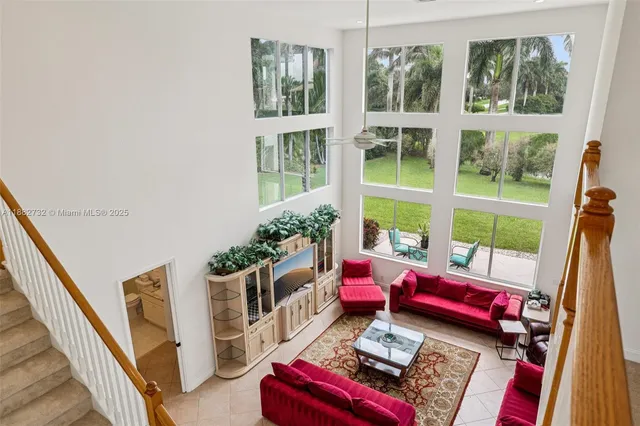 a dining room with furniture potted plants and wooden floor