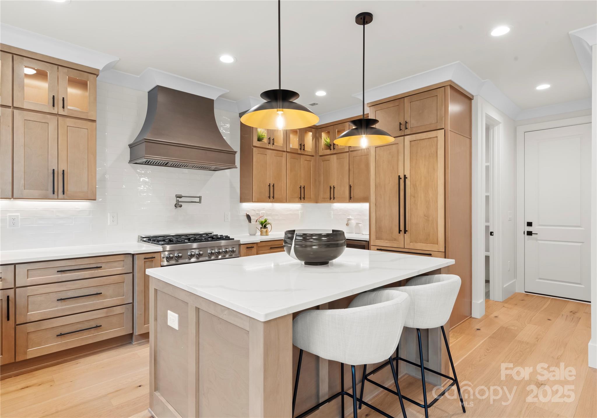 1641 Longfellow Street Charlotte, NC 28205 - Photo 21 of 48 a kitchen that has a stove a table and chairs in it