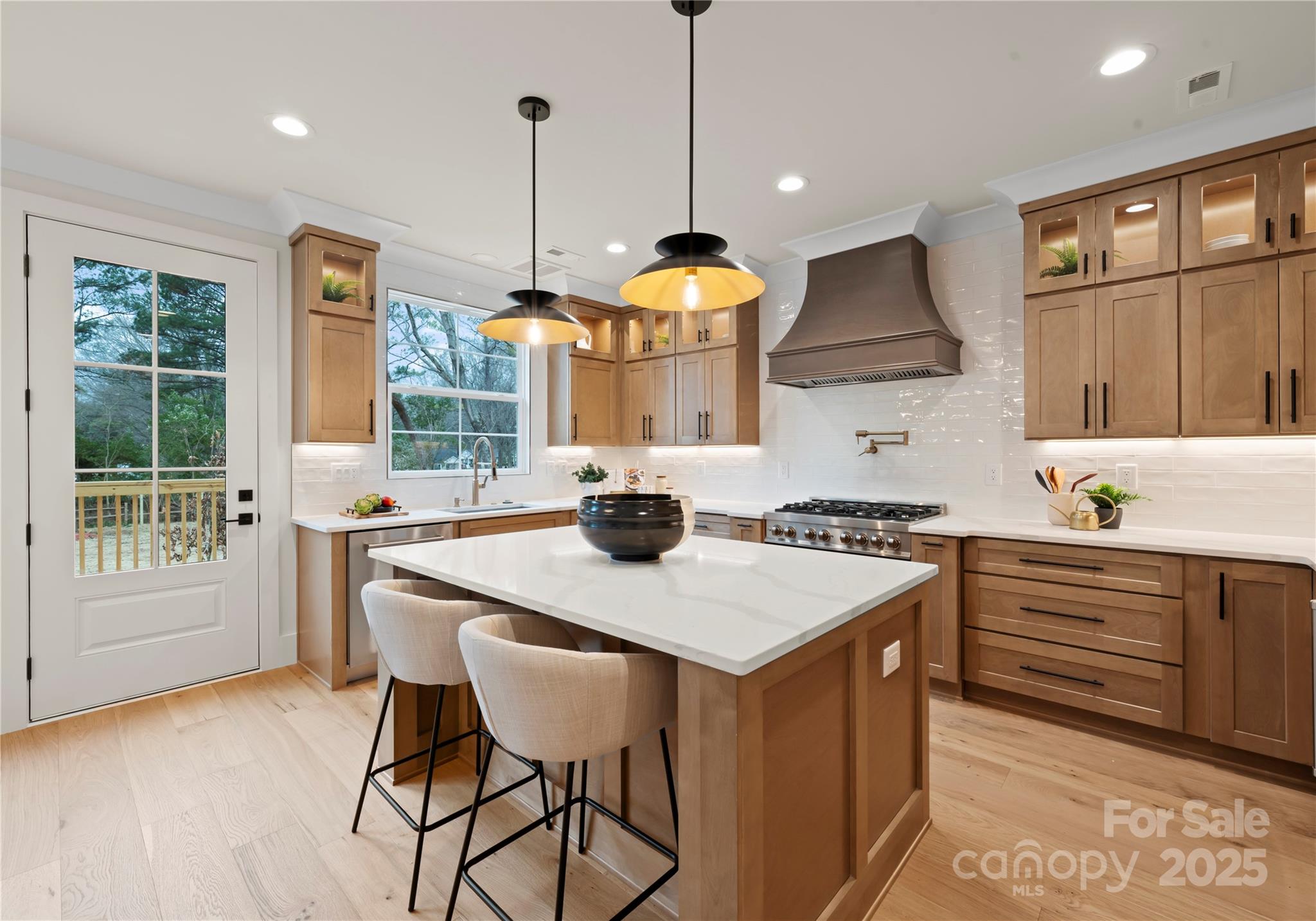 1641 Longfellow Street Charlotte, NC 28205 - Photo 22 of 48 a kitchen with a stove a refrigerator a sink and chairs