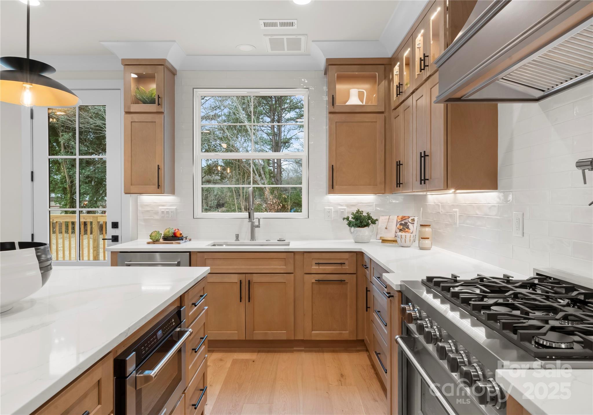 1641 Longfellow Street Charlotte, NC 28205 - Photo 23 of 48 a kitchen with a sink stove top oven and cabinets