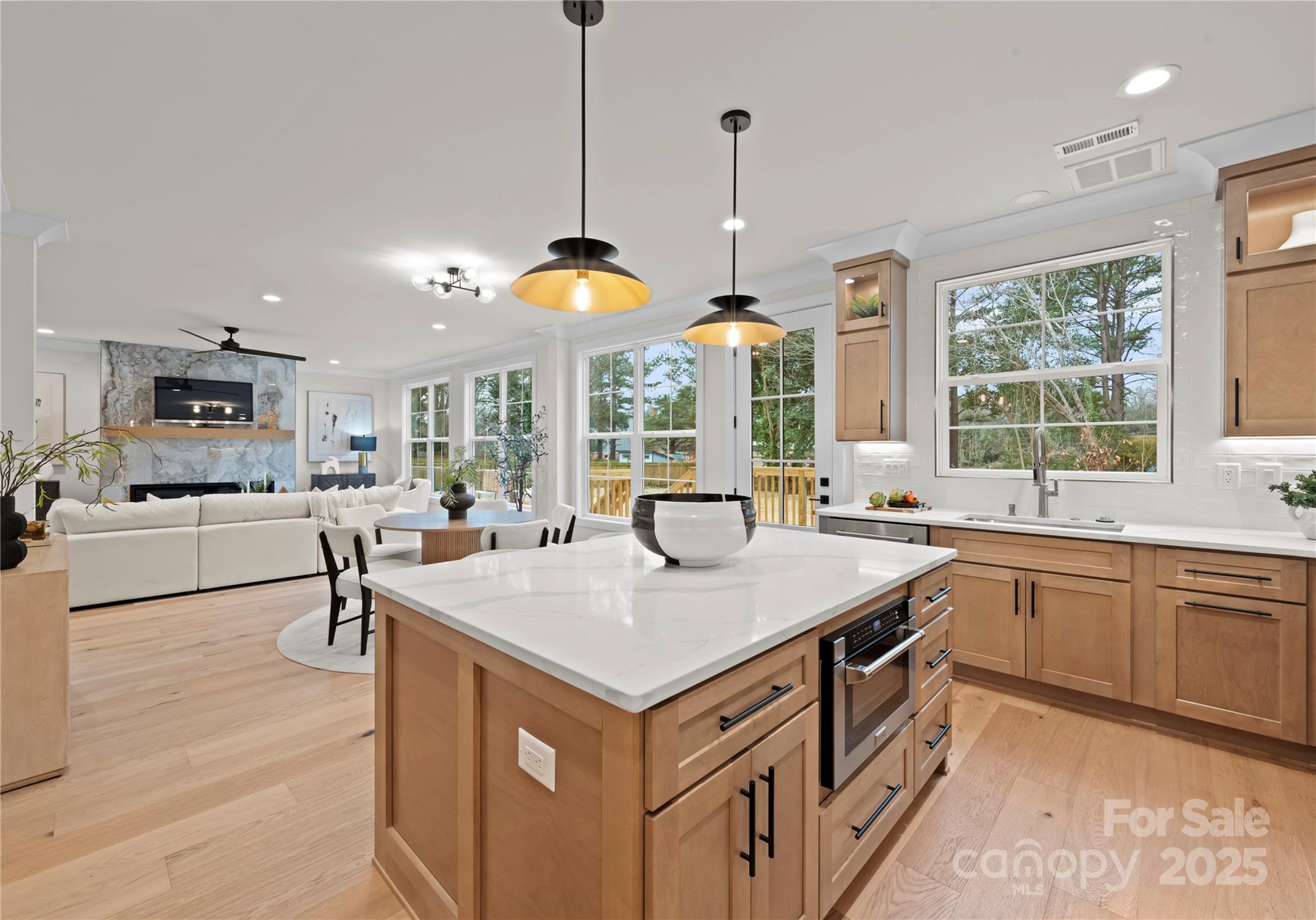1641 Longfellow Street Charlotte, NC 28205 - Photo 25 of 48 a kitchen that has a lot of cabinets a sink and a wooden floor