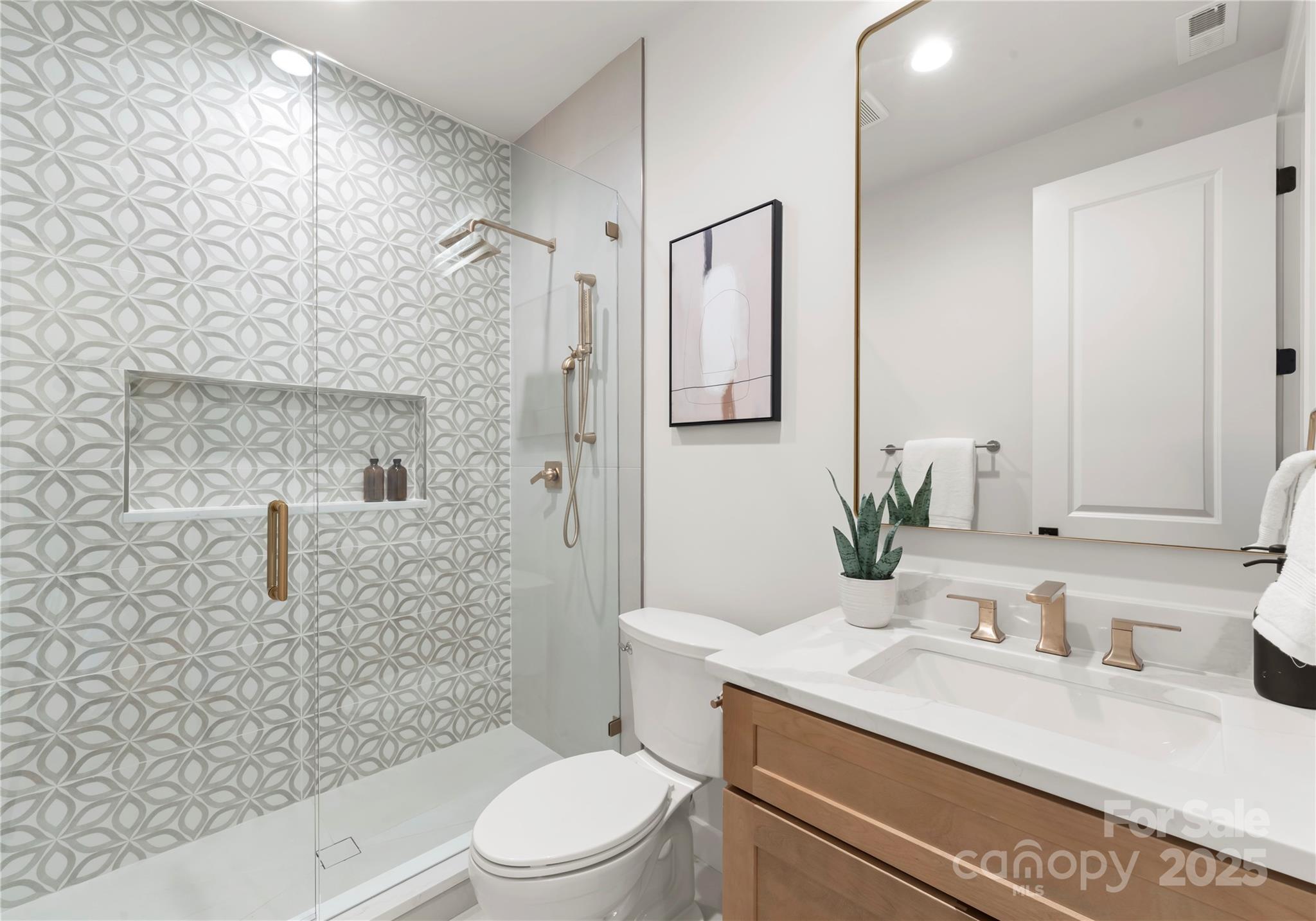 1641 Longfellow Street Charlotte, NC 28205 - Photo 9 of 48 a bathroom with a granite countertop sink a toilet and shower