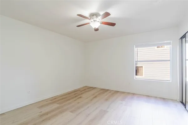 a view of an empty room with a ceiling fan