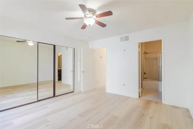 a bathroom with a granite countertop sink mirror and a bathtub