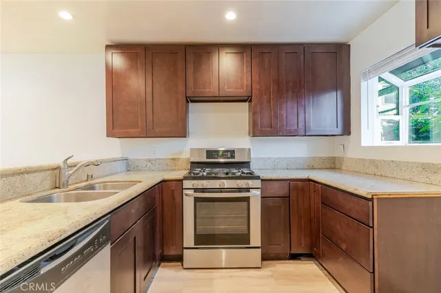 a view of empty room with wooden floor and fireplace