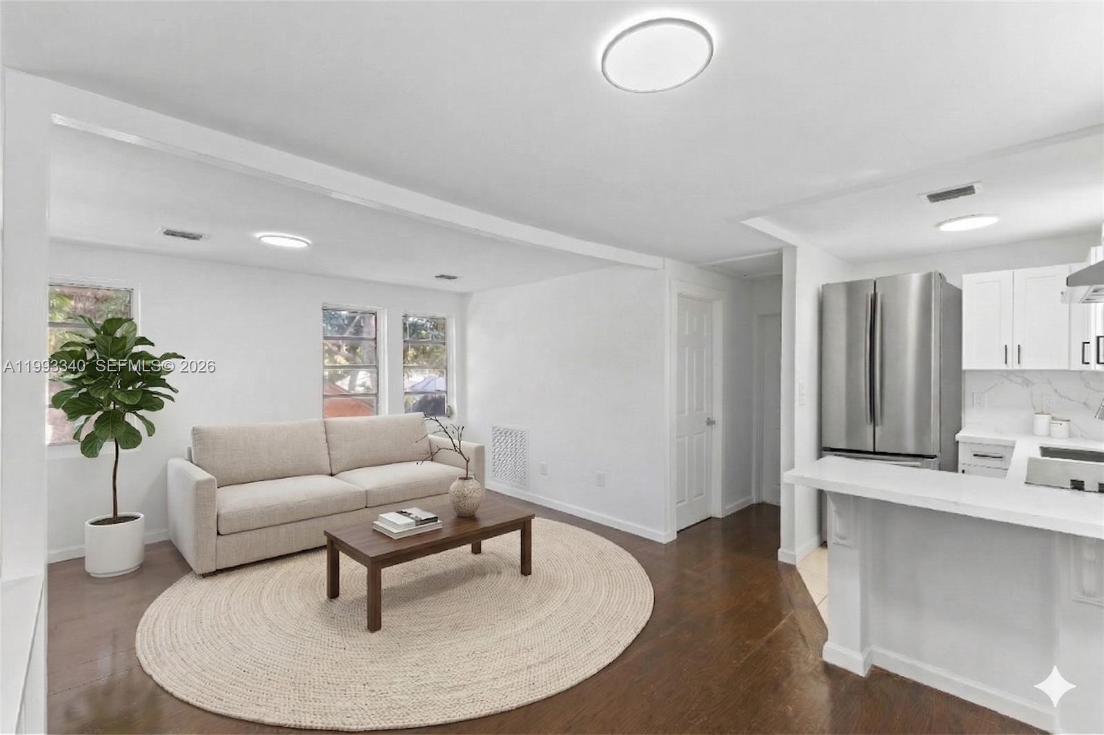 1408 Southwest 19th Terrace, Unit 1406 Miami, FL 33145 - Photo 1 of 12 a living room with furniture and a potted plant