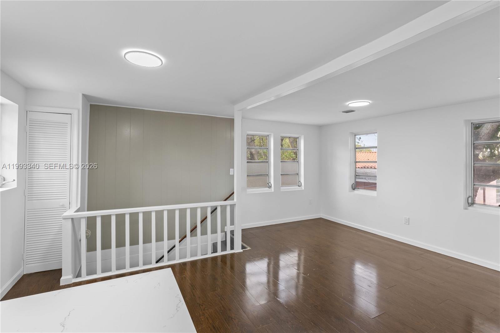 1408 Southwest 19th Terrace, Unit 1406 Miami, FL 33145 - Photo 3 of 12 a view of wooden floor and windows in a room