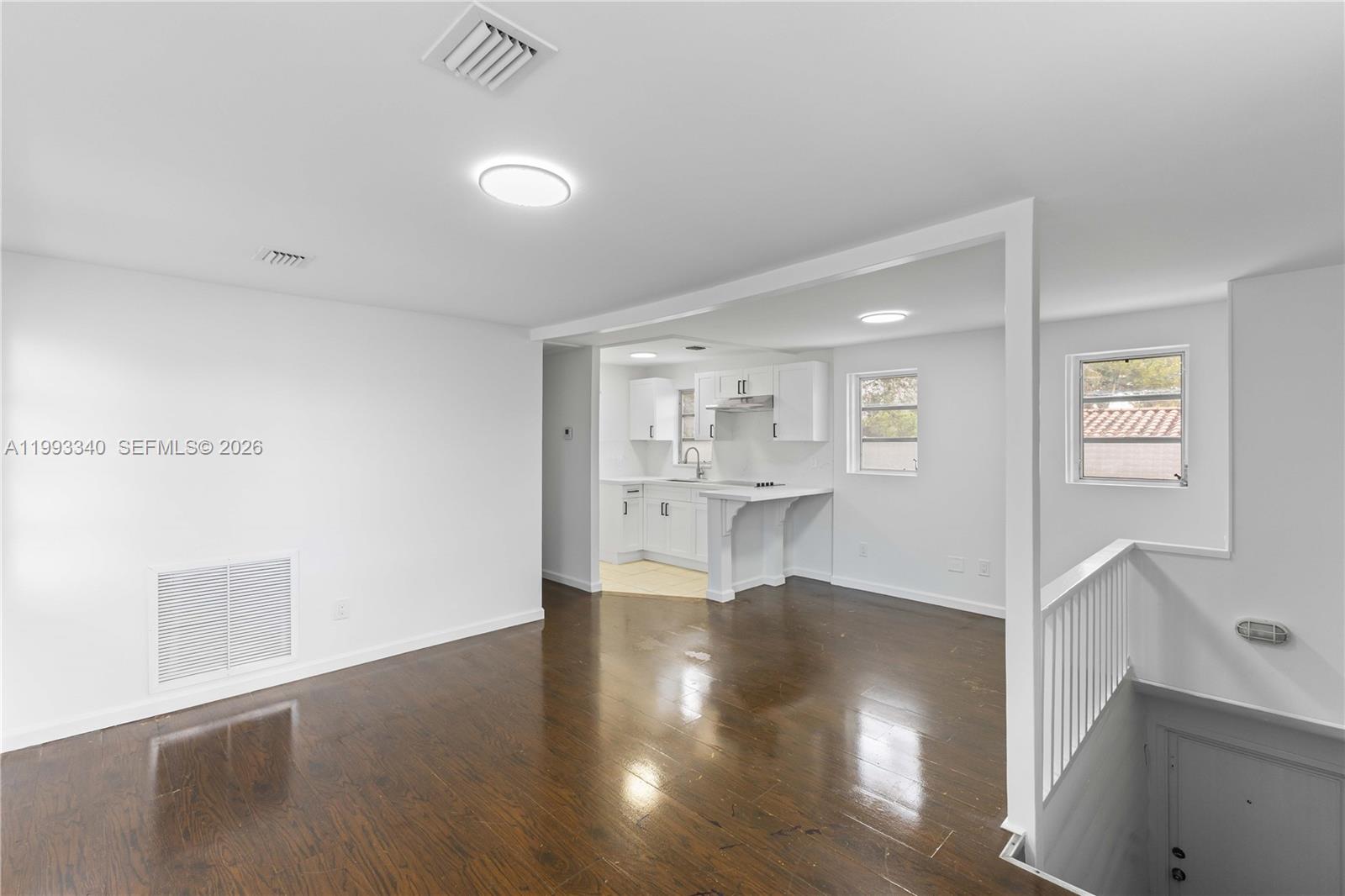 1408 Southwest 19th Terrace, Unit 1406 Miami, FL 33145 - Photo 4 of 12 a view of a living room and kitchen with furniture and wooden floor