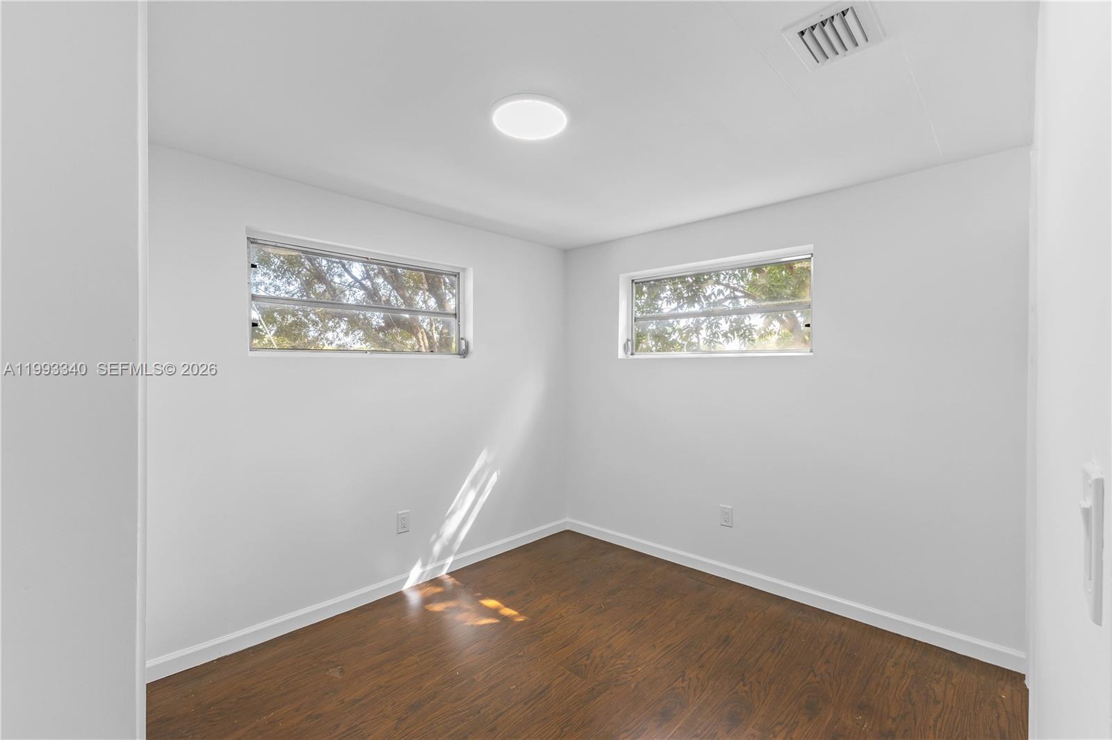 1408 Southwest 19th Terrace, Unit 1406 Miami, FL 33145 - Photo 8 of 12 an empty room with a painting on the wall