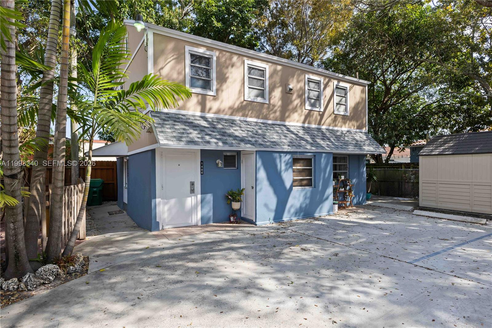 1408 Southwest 19th Terrace, Unit 1406 Miami, FL 33145 - Photo 10 of 12 a front view of a house with a yard
