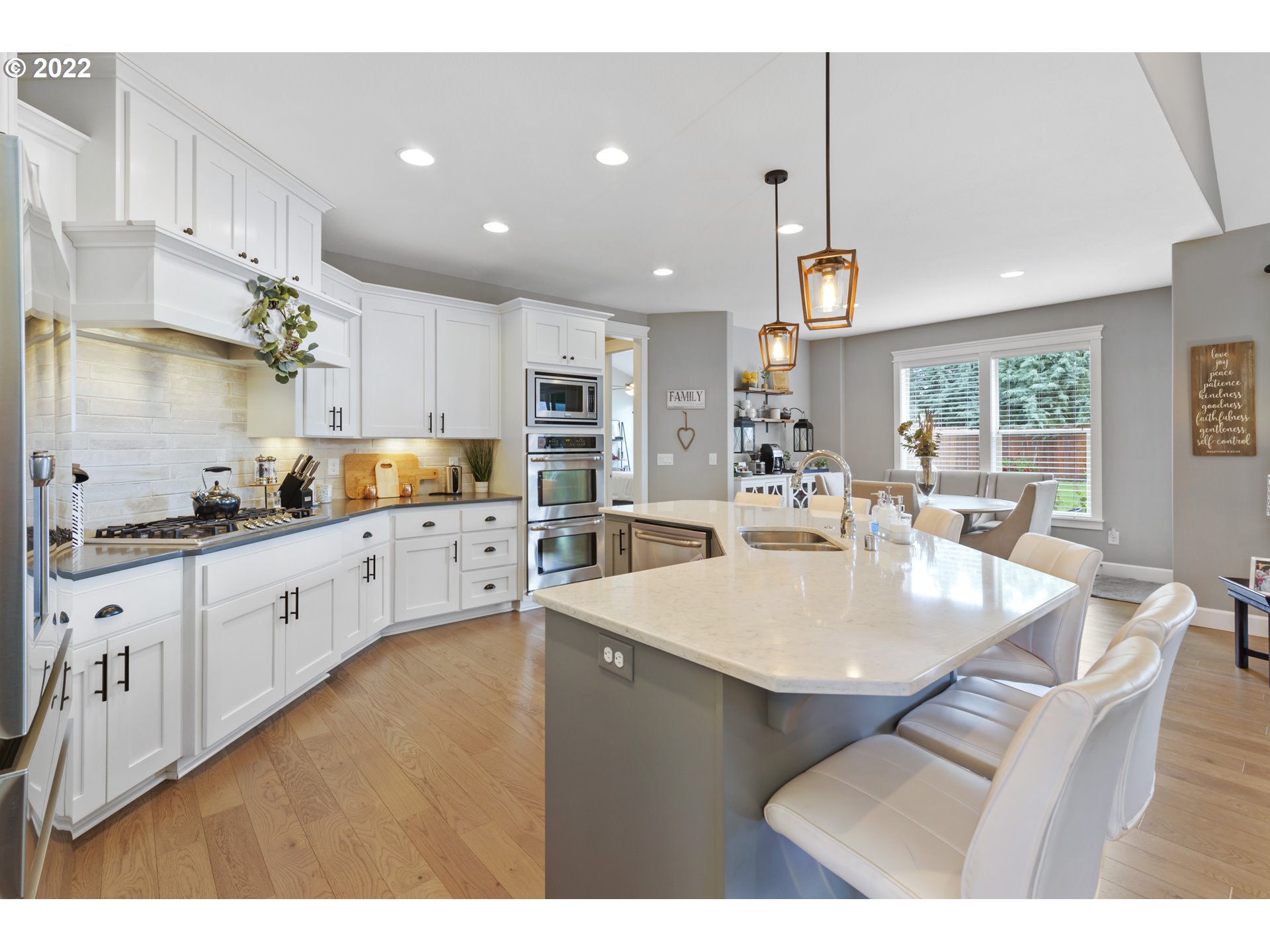 2600 Northeast 176th Street Ridgefield, WA 98642 - Photo 8 of 24 a kitchen with stainless steel appliances kitchen island granite countertop a stove a sink a dining table and chairs
