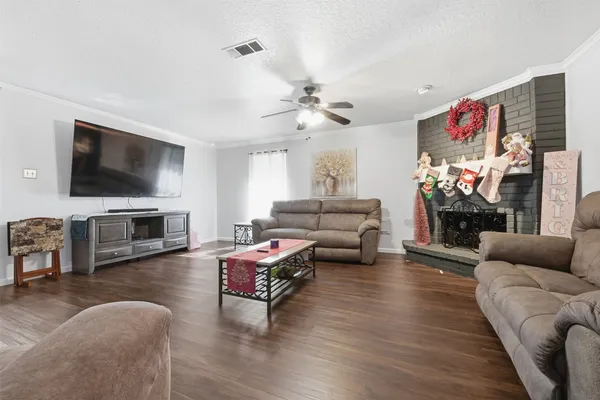 a living room with furniture flat screen tv and fireplace