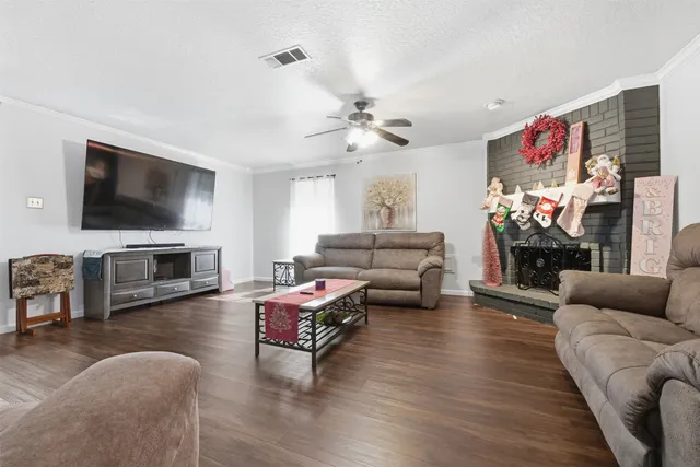a living room with furniture flat screen tv and fireplace