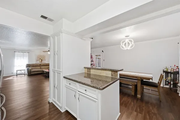 a kitchen with a table and chairs