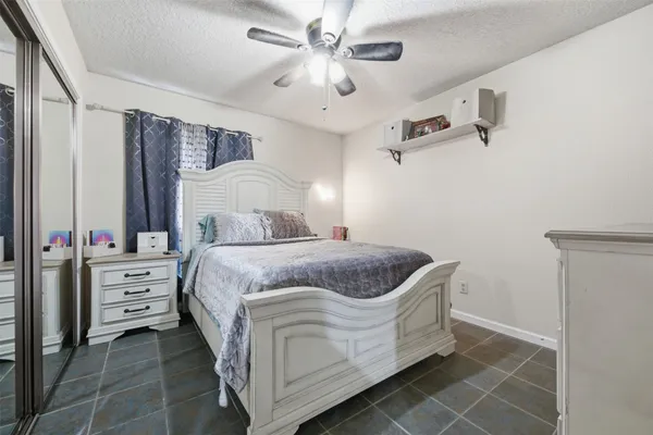 a spacious bedroom with a bed and a chandelier