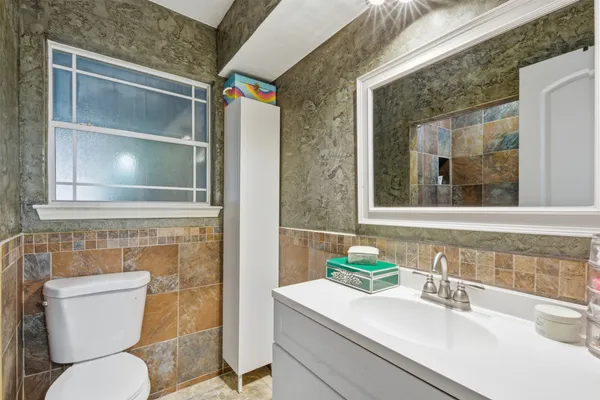 a bathroom with a sink toilet and shower