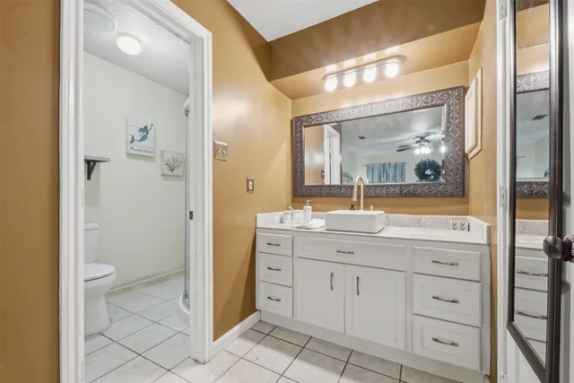 a white toilet sitting next to a bathroom sink