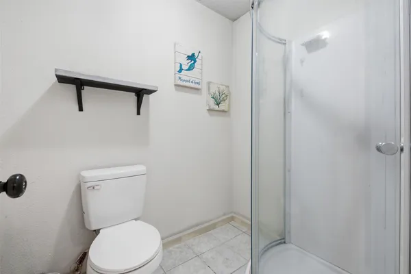 a white toilet sitting next to a bathroom sink