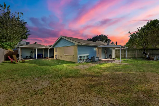 a view of an house with backyard space and garden